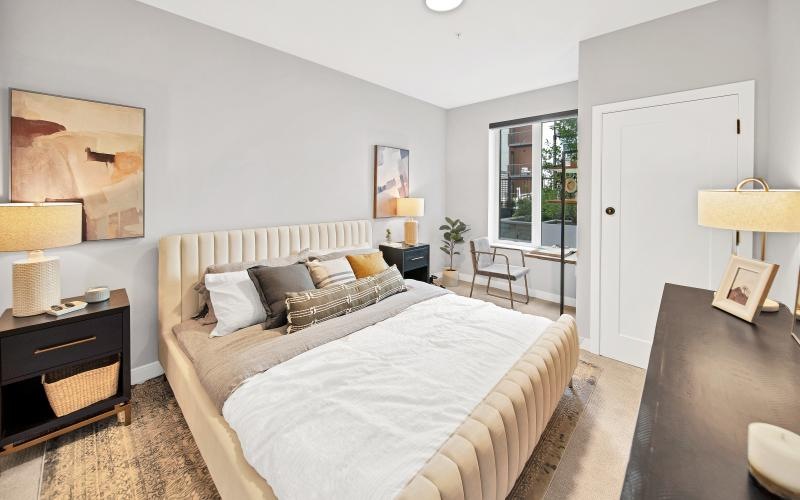 a bedroom with a bed and a table