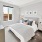a bedroom with a bed and lamps