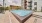 a swimming pool in a courtyard between buildings