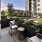 a patio with chairs and a table